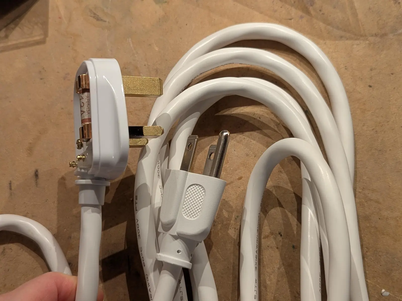 white cord with a British plug at one end and an American 3 prong plug at the other!