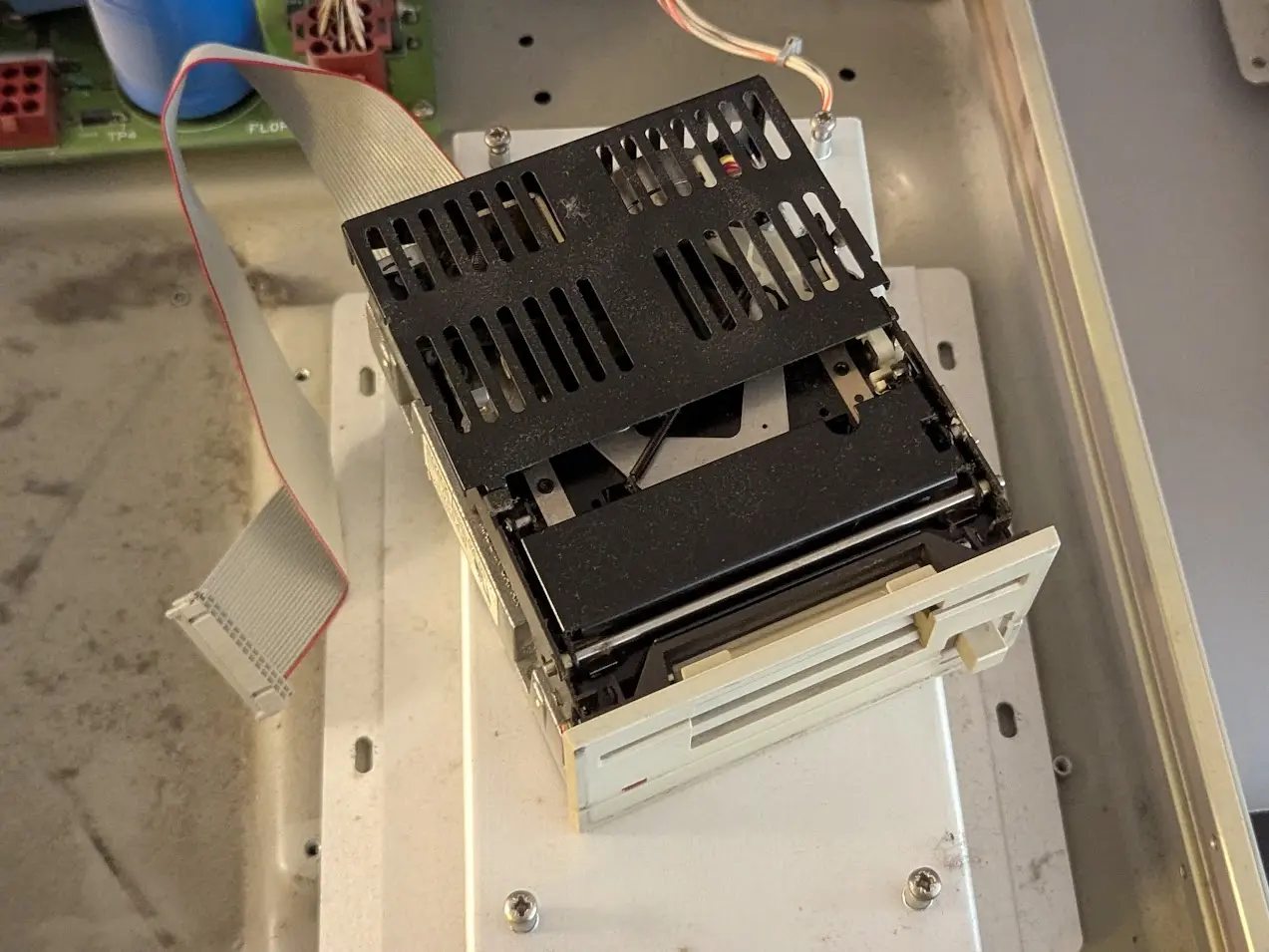 odd-looking full height 3.5" floppy drive with a black vented sheet metal cover on  top and a suspiciously narrow ribbon cable