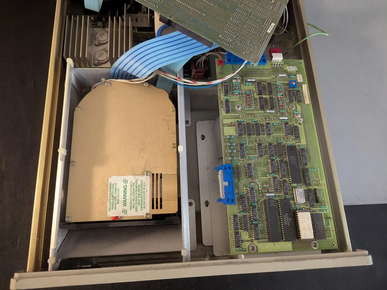 drive enclosure with the lid off. there are some circuit boards and on the left side is the top of a Seagate hard drive.