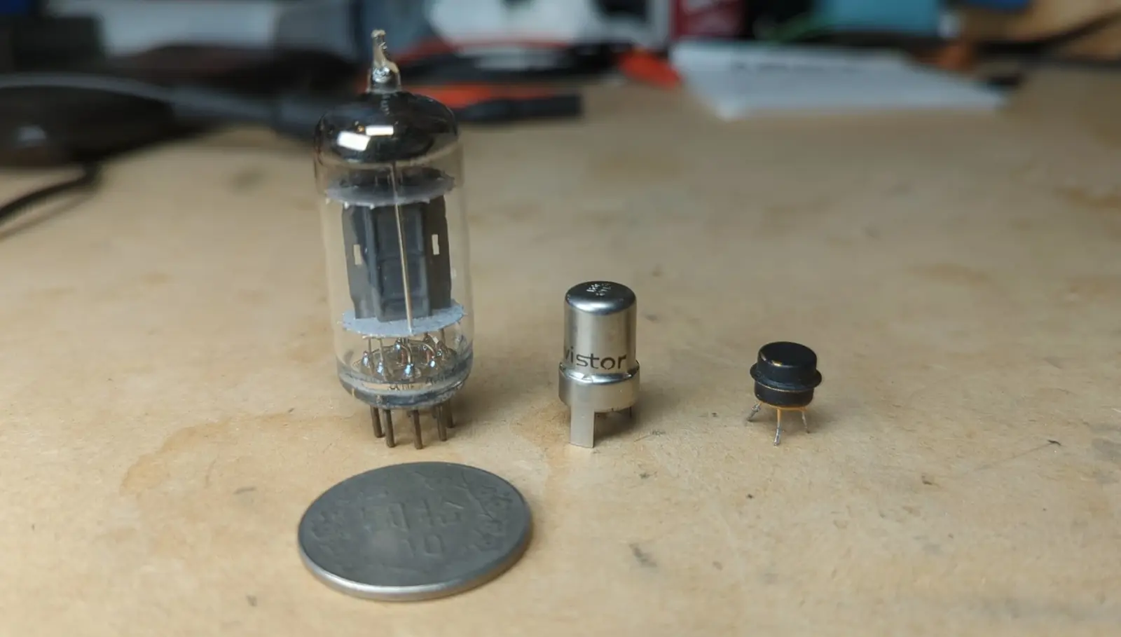 the glass vacuum tube is about 4cm tall but it seems huge compared to the transistor and the Nuvistor. the Nuvistor is around the same diameter as the transistor but about twice as tall.